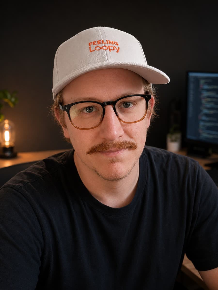 Colin Johnson at his desk, wearing a cap that says Feeling Loopy